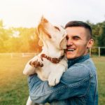 Man holding happy dog
