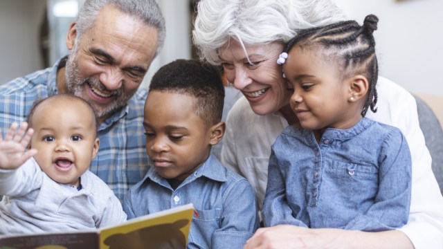 Grandparents reading to grandchildren